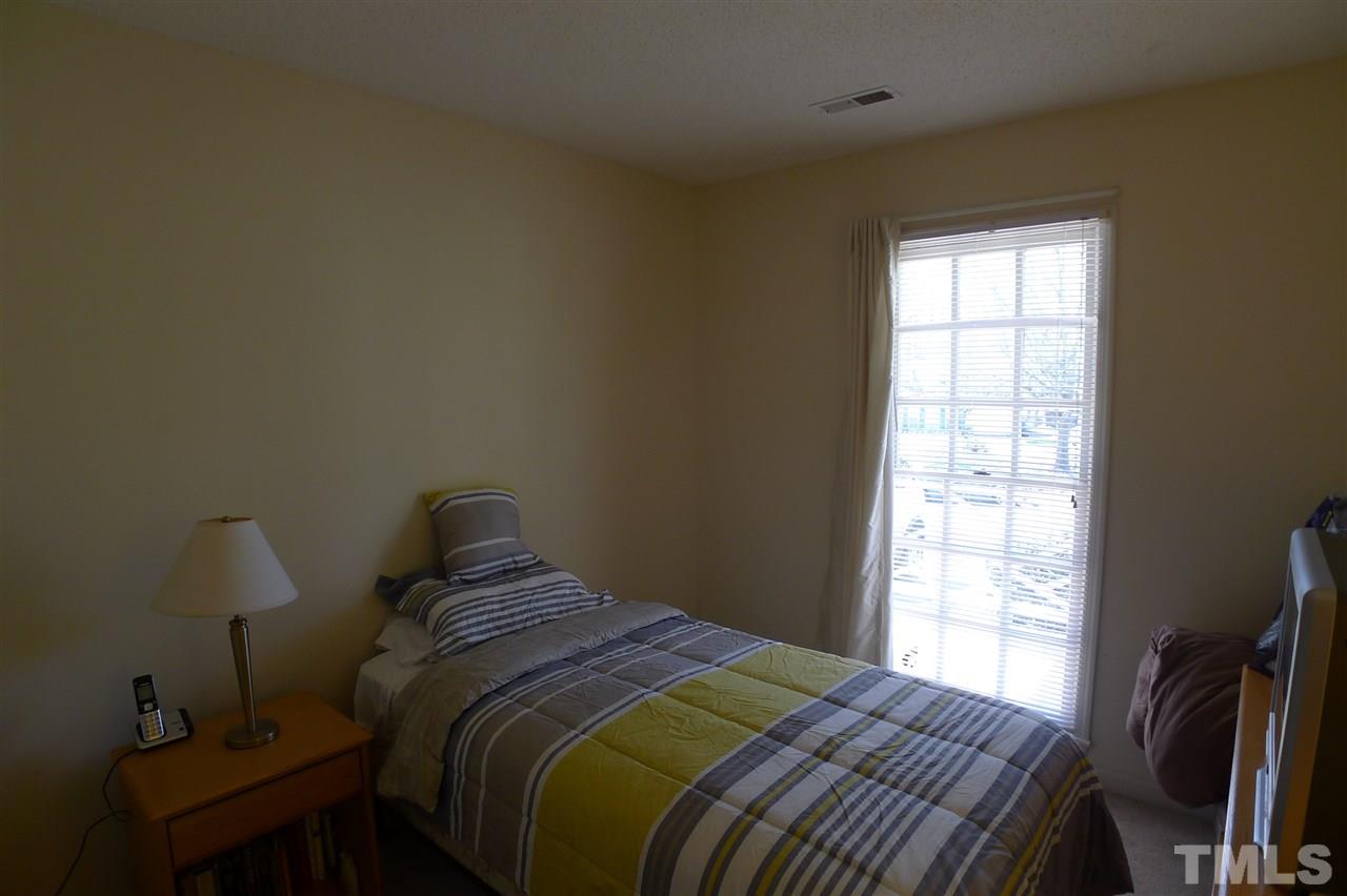 2708 Heathersmith Court Raleigh, NC 27604 - Photo 15 of 25 a bedroom with a bed and a window