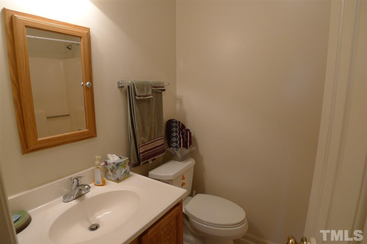 2708 Heathersmith Court Raleigh, NC 27604 - Photo 16 of 25 a bathroom with a sink a toilet and mirror