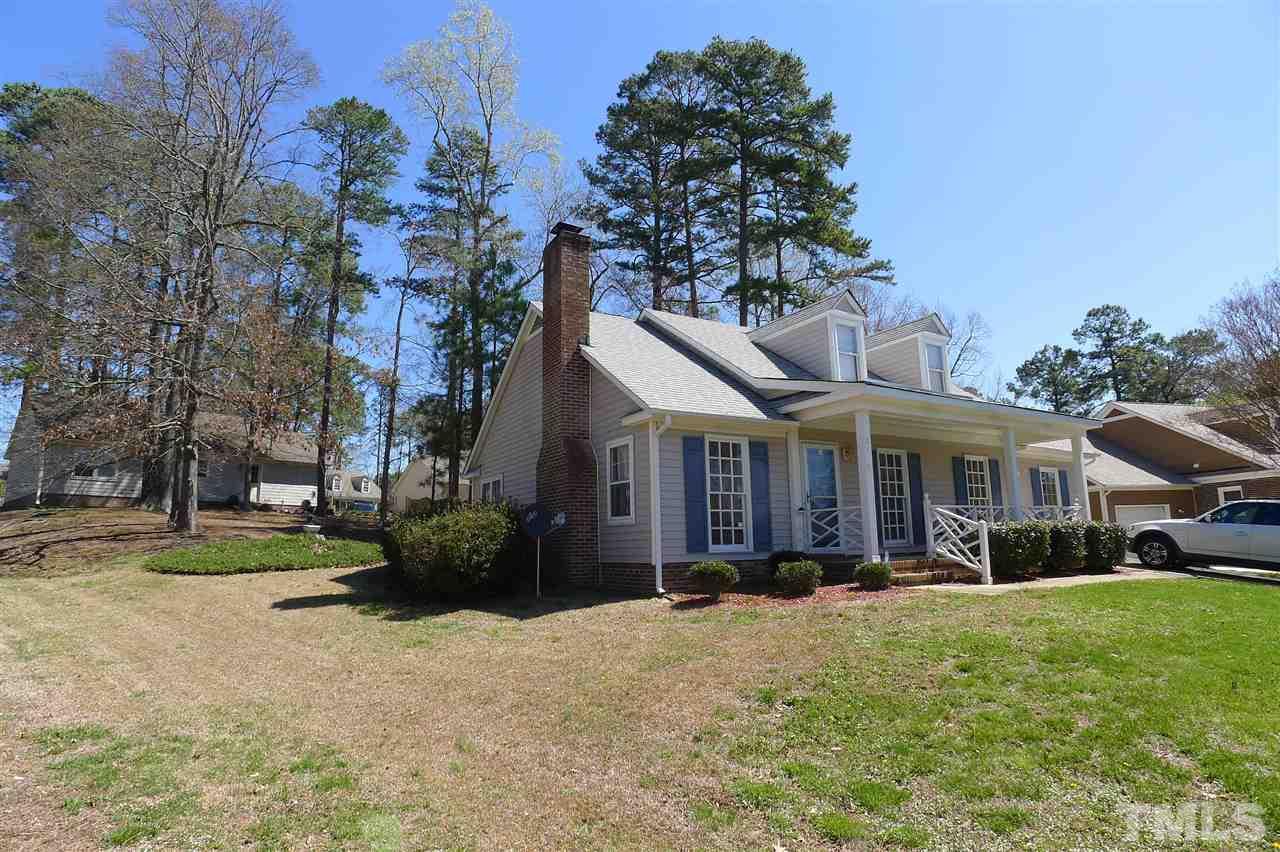 2708 Heathersmith Court Raleigh, NC 27604 - Photo 19 of 25 a front view of a house with a garden and trees