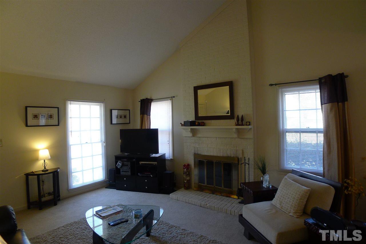2708 Heathersmith Court Raleigh, NC 27604 - Photo 5 of 25 a living room with furniture and a fireplace