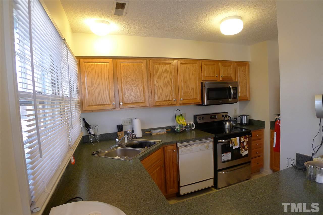 2708 Heathersmith Court Raleigh, NC 27604 - Photo 8 of 25 a kitchen with a sink cabinets and a window