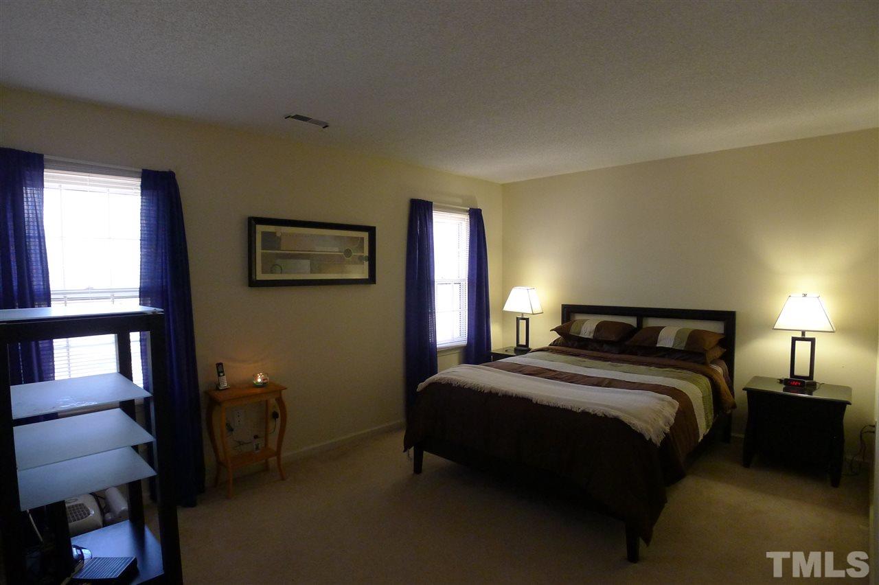 2708 Heathersmith Court Raleigh, NC 27604 - Photo 9 of 25 a bedroom with a bed and a lamp