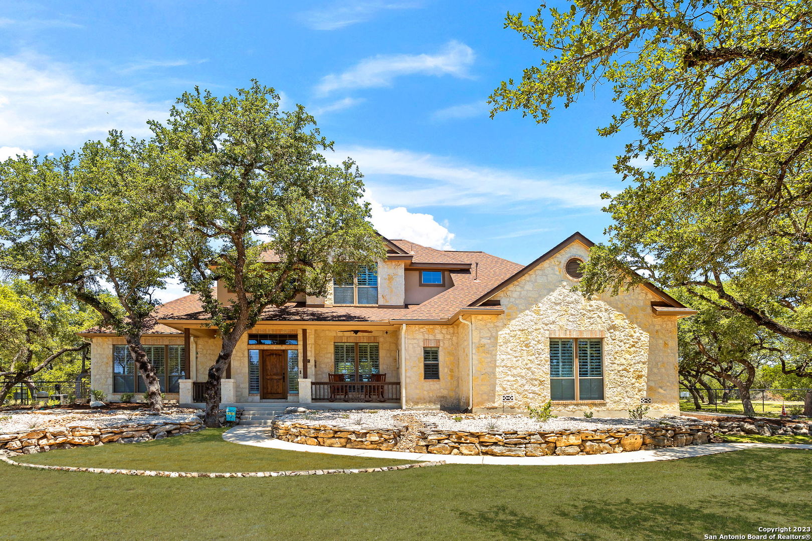 a front view of a house with swimming pool and dining table and chairs