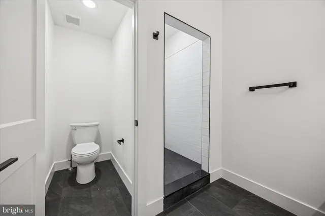 a bathroom view of a toilet and a sink
