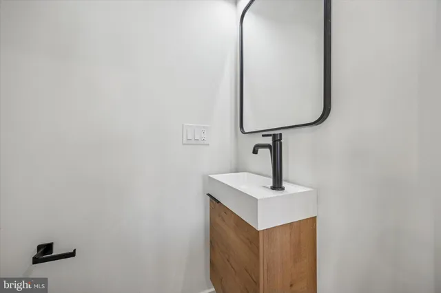 a close view of light fixtures and bathroom with a sink