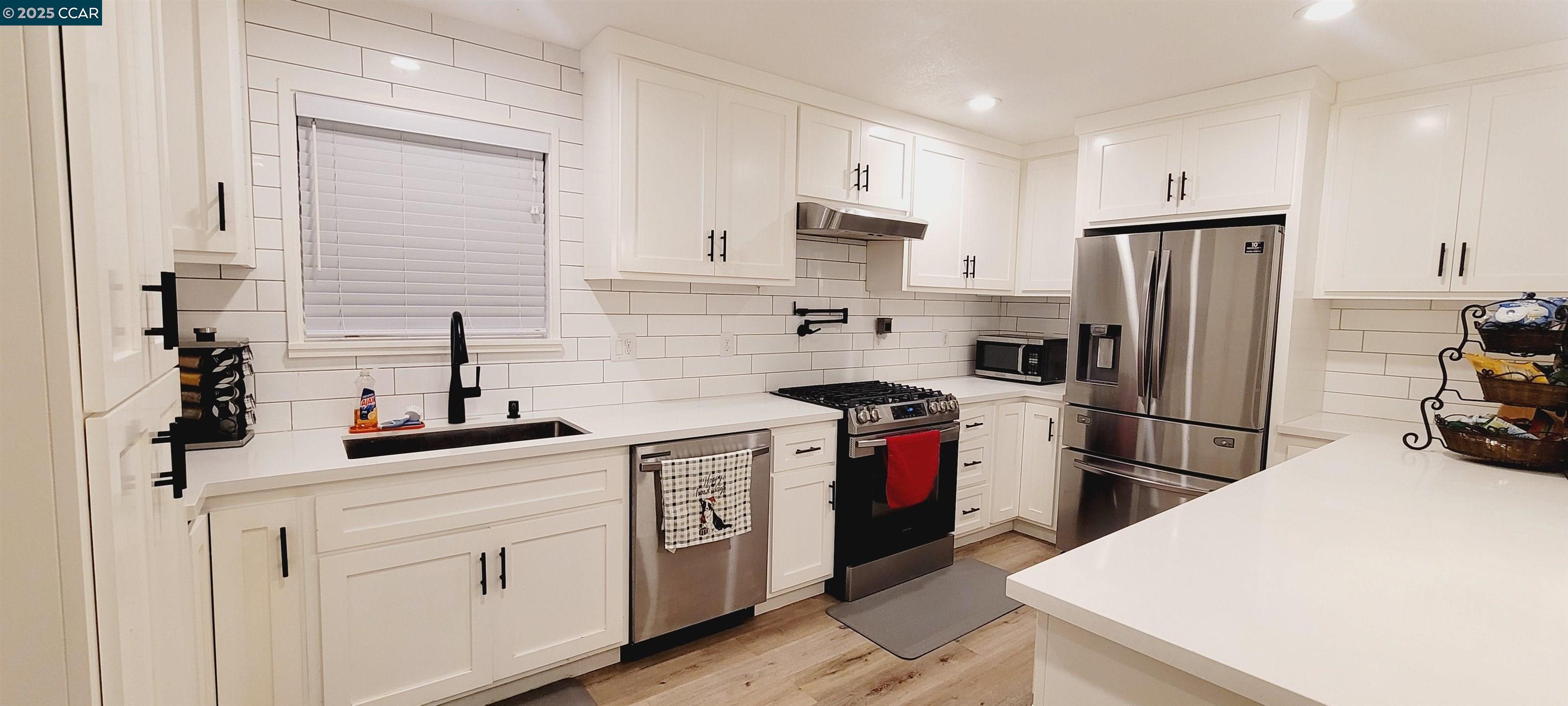 2744 El Rey Street Antioch, CA 94509 - Photo 11 of 23 a kitchen with a sink a stove and refrigerator