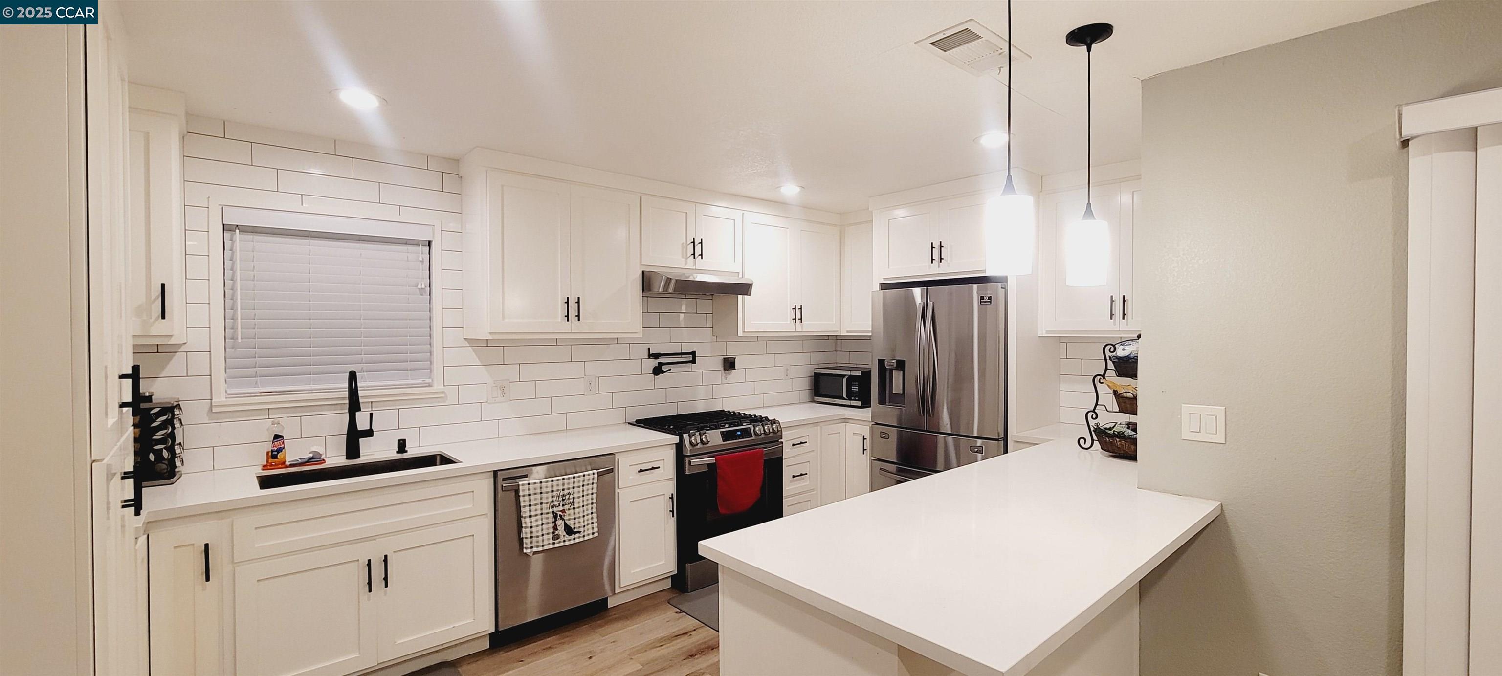 2744 El Rey Street Antioch, CA 94509 - Photo 12 of 23 a kitchen with white cabinets and stainless steel appliances