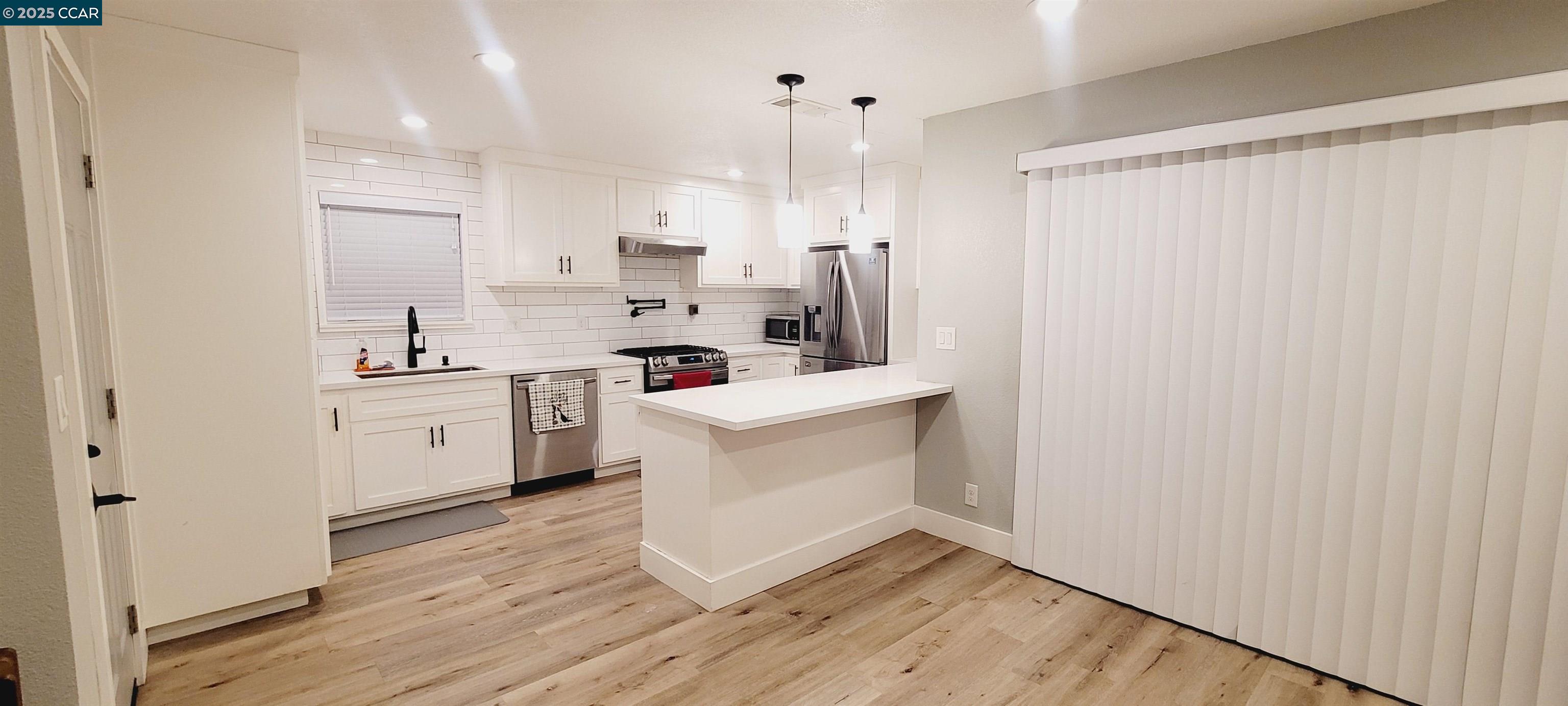 2744 El Rey Street Antioch, CA 94509 - Photo 14 of 23 a kitchen with white cabinets and white appliances