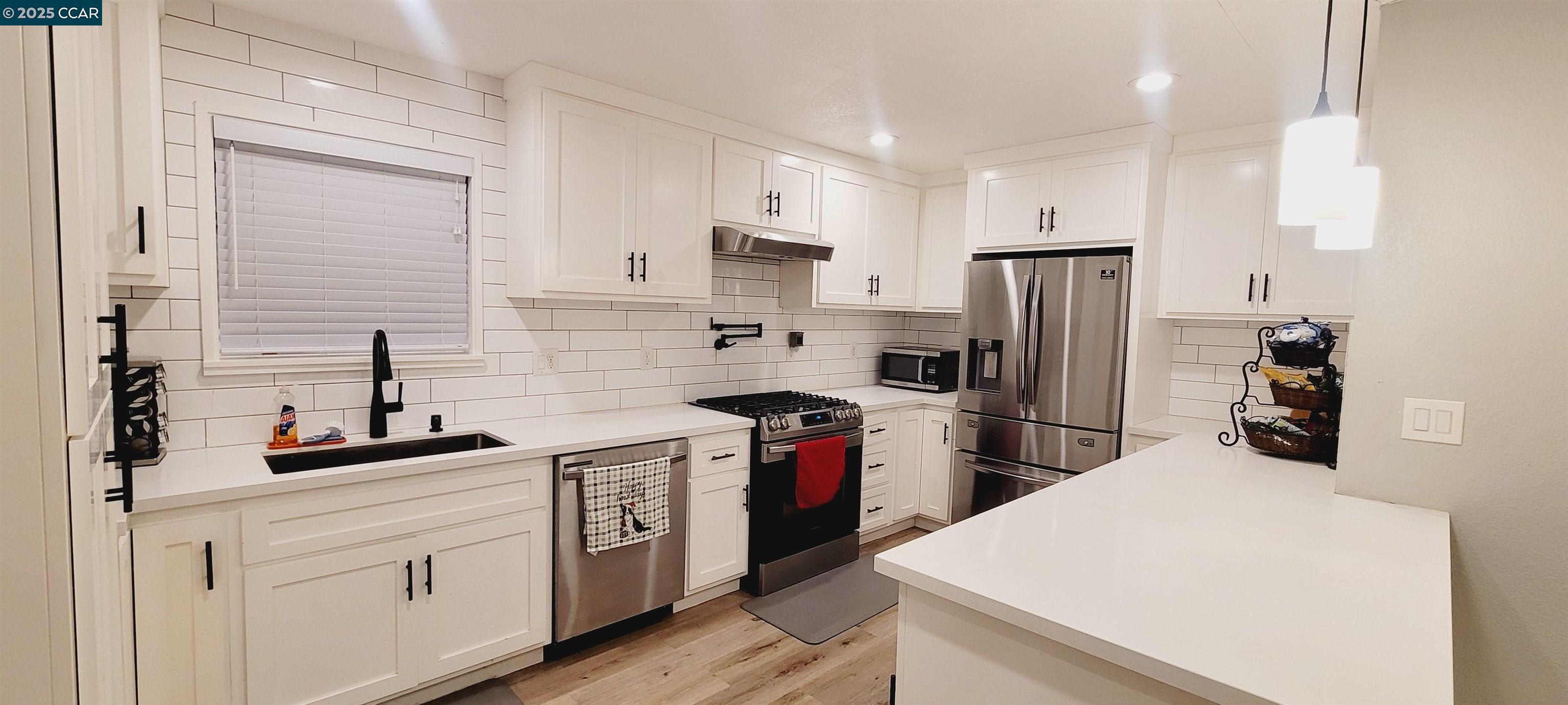 2744 El Rey Street Antioch, CA 94509 - Photo 4 of 23 a kitchen with a sink a refrigerator and cabinets