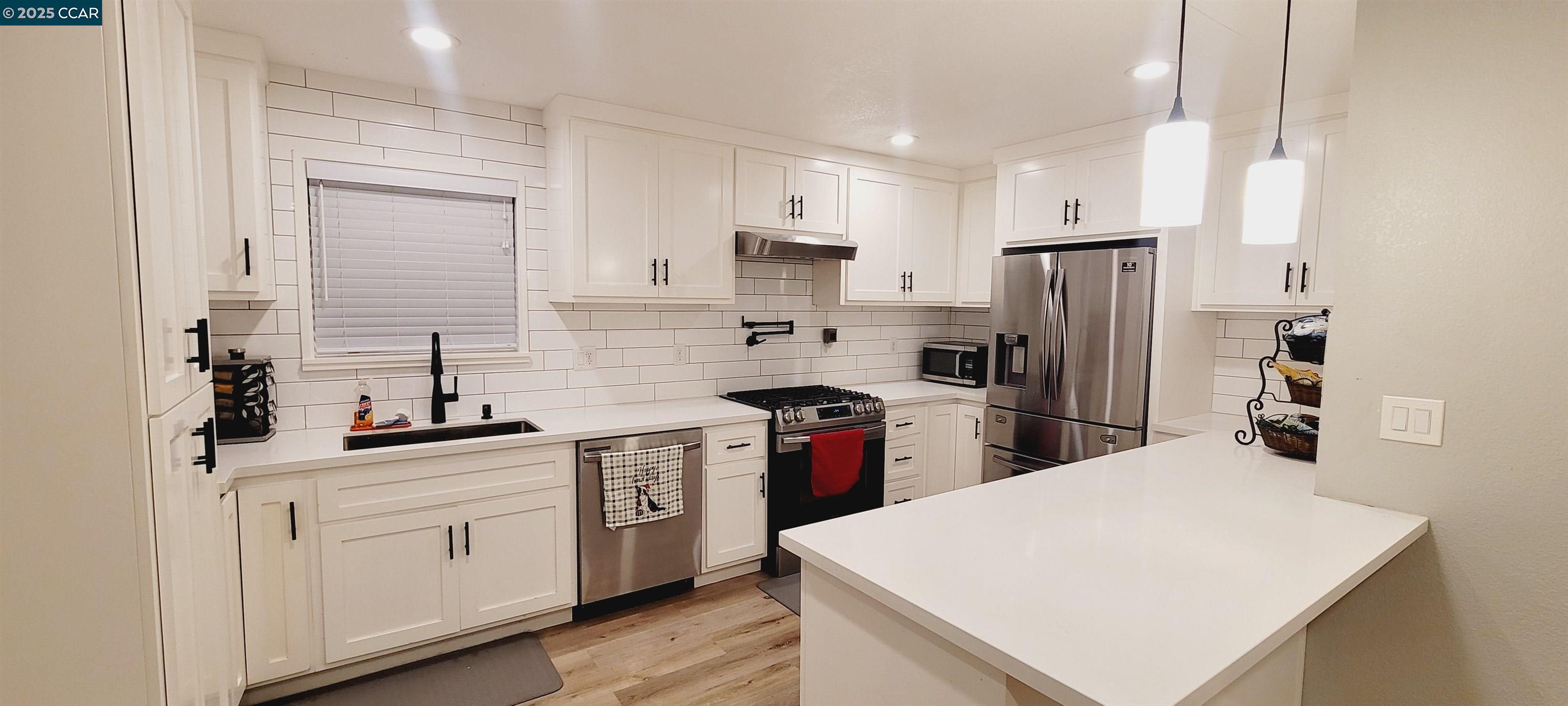 2744 El Rey Street Antioch, CA 94509 - Photo 5 of 23 a kitchen with white cabinets and stainless steel appliances