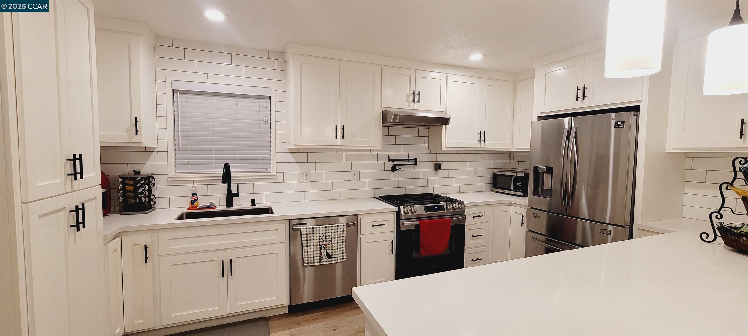 2744 El Rey Street Antioch, CA 94509 - Photo 10 of 23 a kitchen with stainless steel appliances a sink stove refrigerator and cabinets