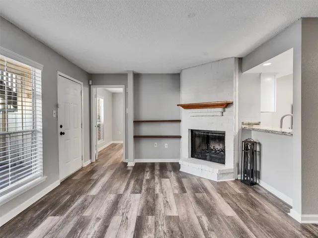 a view of a livingroom with a fireplace and cabinet