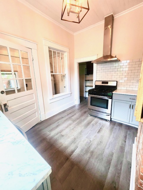 1208 West Whitner Street Anderson, SC 29625 - Photo 5 of 23 This bright kitchen features a gas range with moden hood.