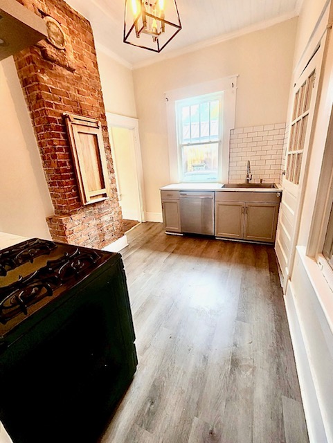 1208 West Whitner Street Anderson, SC 29625 - Photo 6 of 23 Modern kitchen features modern flooring and a classic brick accent.