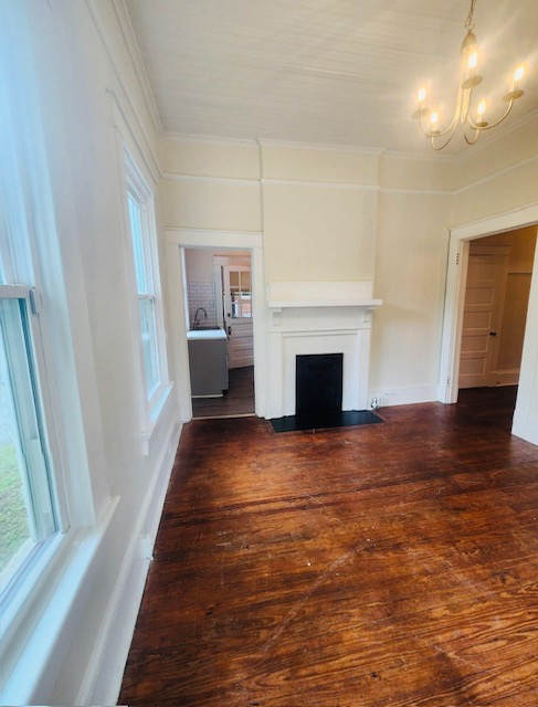 1208 West Whitner Street Anderson, SC 29625 - Photo 7 of 23 This living area features a fireplace, rich hardwood floors, and ample natural light.