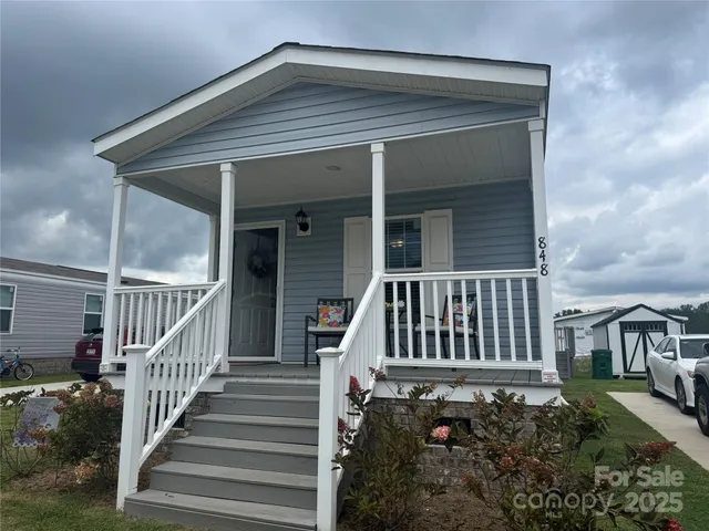 a view of a house with wooden floor fence and a porch