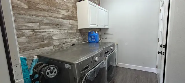 a living room with furniture and a refrigerator