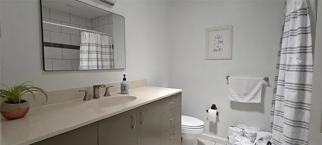 a bathroom with a shower and toilet