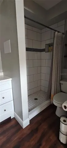 a bedroom with a bed and a lamp on the dresser