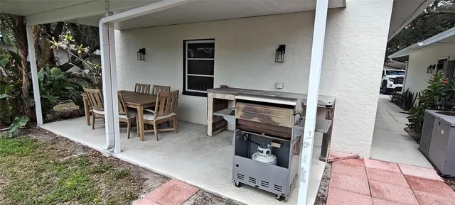 a backyard of a house with lots of green space and outdoor seating