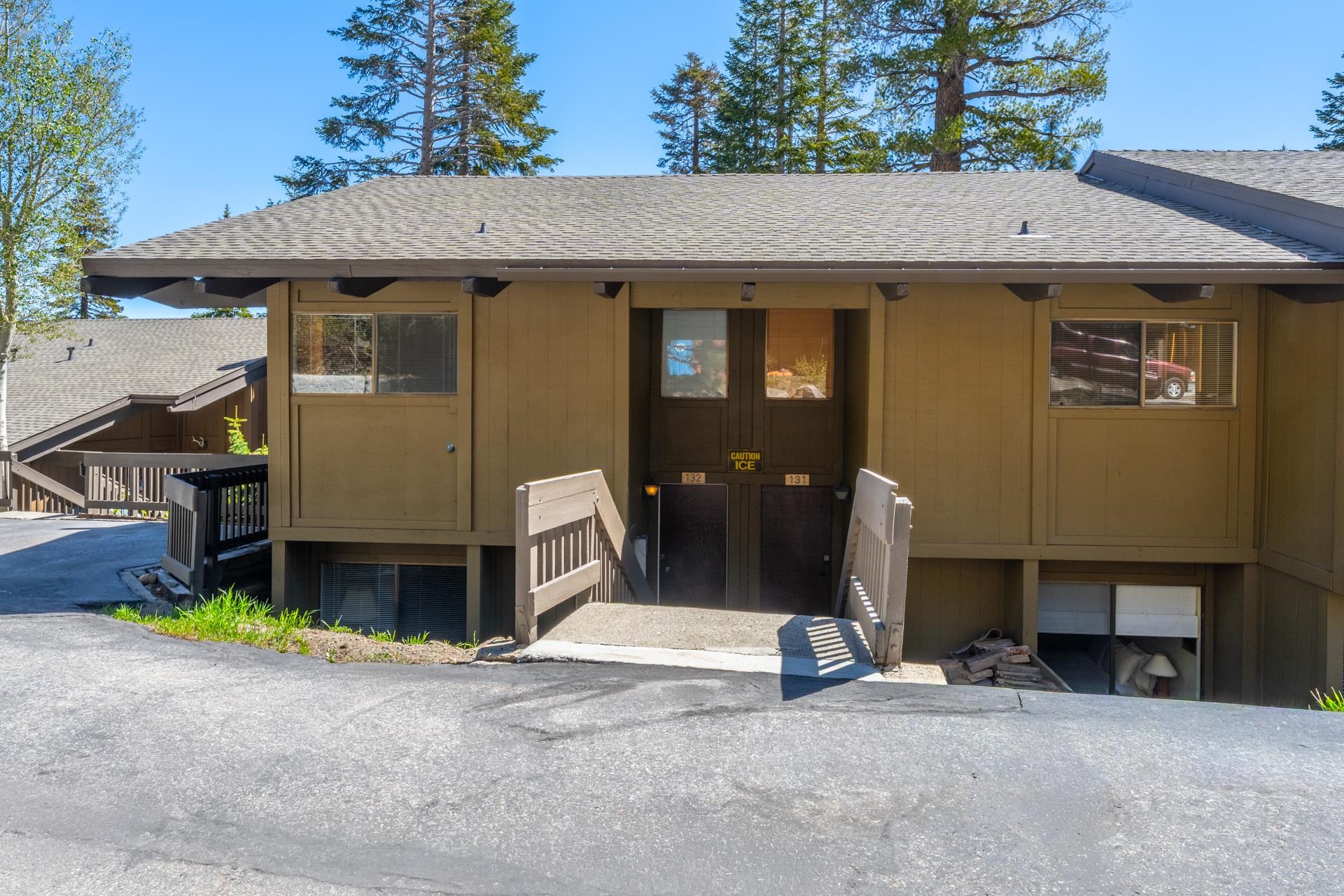 94 John Muir Road, Unit 132 Mammoth Lakes, CA 93546 - Photo 2 of 58 a front view of a house with a yard and garage