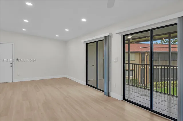 a view of an empty room with glass door