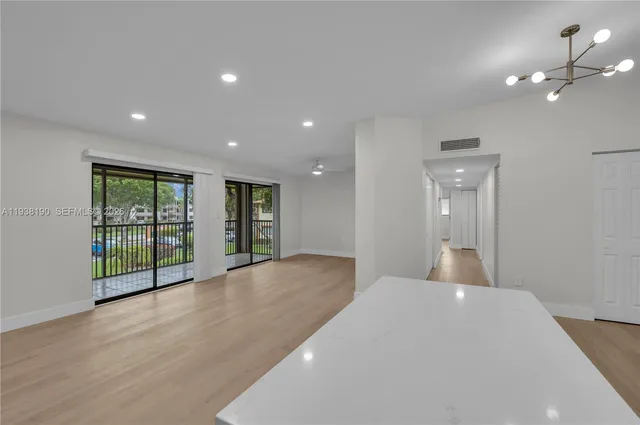 a big room with wooden floor and windows