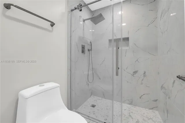 a bathroom with a shower and toilet