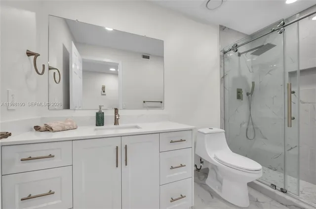 a bathroom with a toilet sink shower and mirror