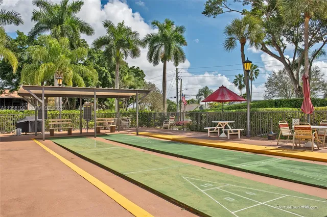 a view of swimming pool with outdoor seating and plants