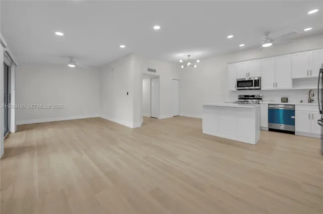 a view of kitchen and kitchen with stainless steel appliances