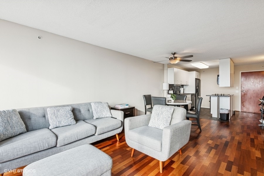 800 Elgin Road, Unit 1502 Evanston, IL 60201 - Photo 3 of 19 a living room with furniture and wooden floor
