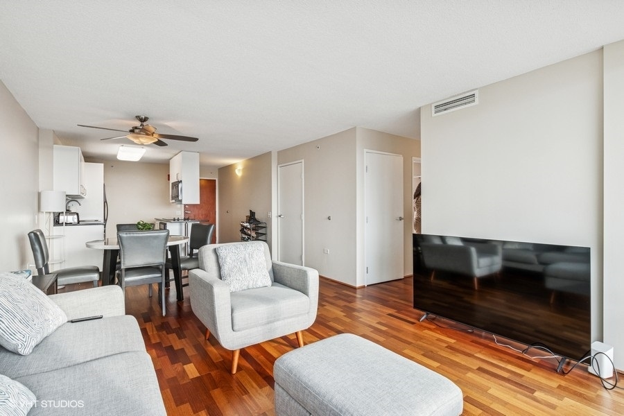800 Elgin Road, Unit 1502 Evanston, IL 60201 - Photo 4 of 19 a living room with furniture and a fireplace