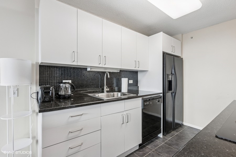 800 Elgin Road, Unit 1502 Evanston, IL 60201 - Photo 5 of 19 a kitchen with stainless steel appliances granite countertop white cabinets and a sink