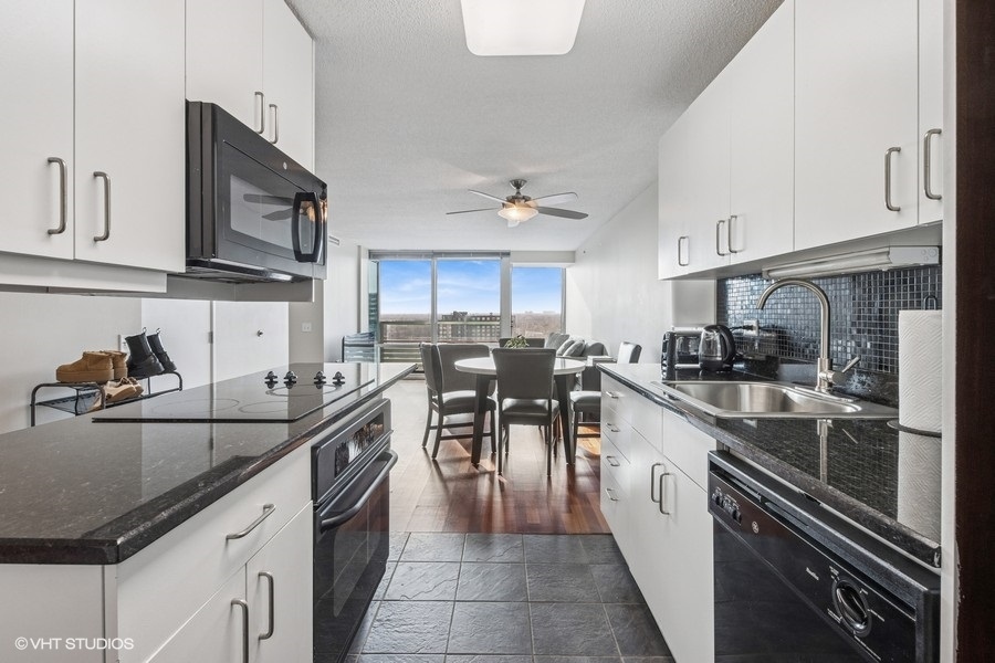 800 Elgin Road, Unit 1502 Evanston, IL 60201 - Photo 7 of 19 a kitchen with stainless steel appliances granite countertop sink stove microwave and cabinets