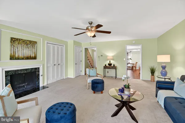 a living room with furniture a fireplace and a table