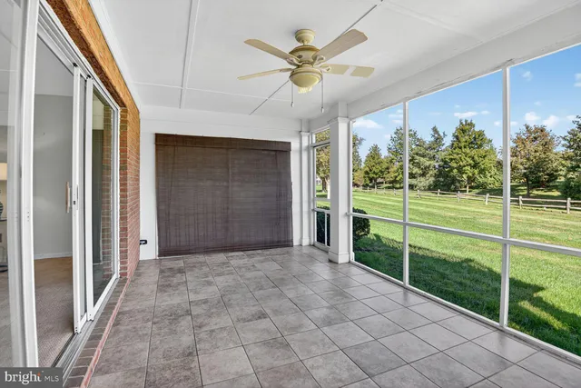 a view of a porch with furniture and garden