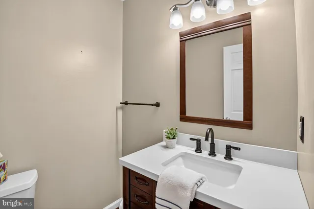 a bathroom with a sink vanity and a mirror