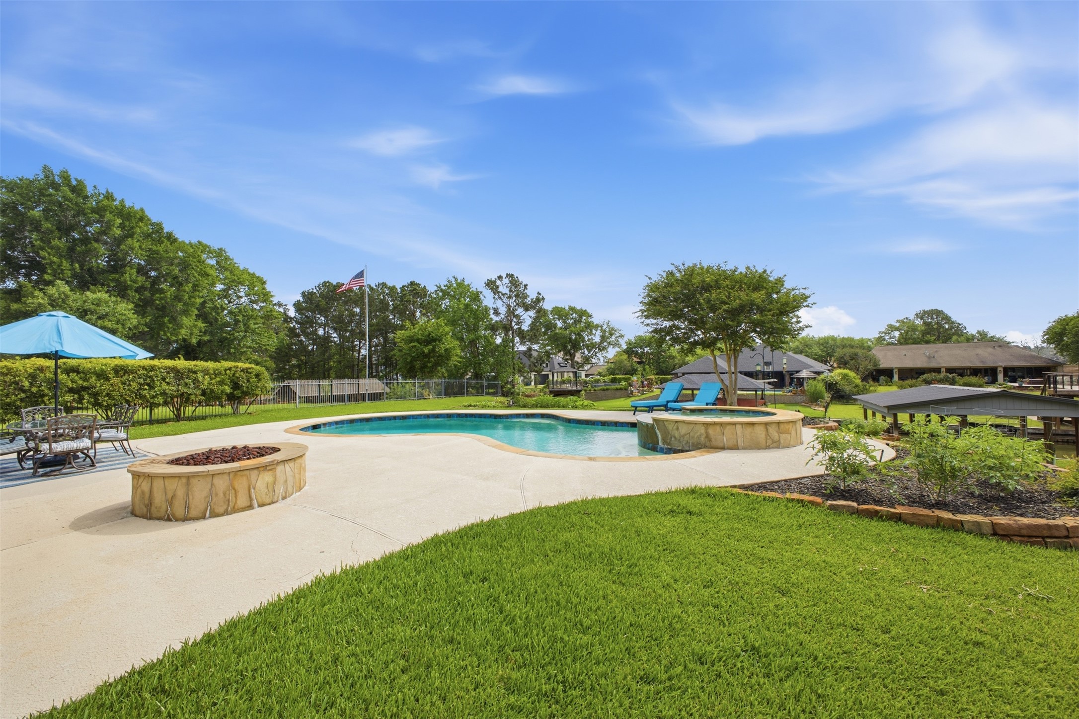 12710 Aries Loop Willis, TX 77318 - Photo 35 of 40 The property features a spacious lawn, a swimming pool with an integrated hot tub, and a fire pit