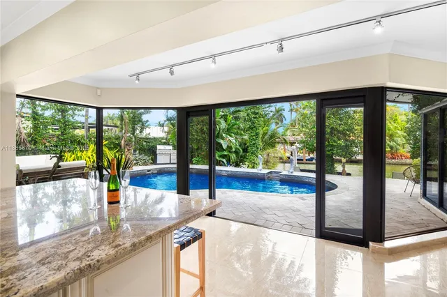 a view of a kitchen with large windows and a table