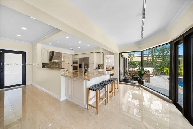 a room with stainless steel appliances lots of counter space cabinets and furniture