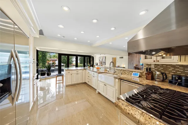 a large white kitchen with lots of counter top space