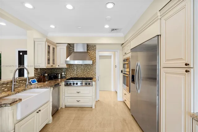 a kitchen with stainless steel appliances a refrigerator sink and stove