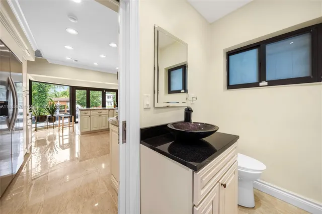a kitchen with a sink a stove and chairs