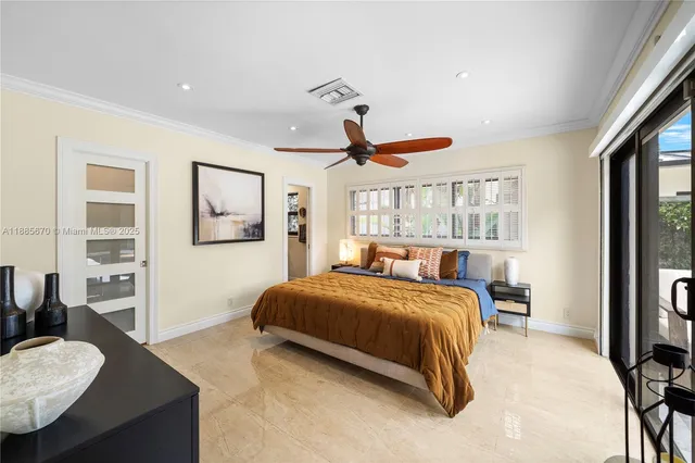 a bedroom with a bed couch and a window