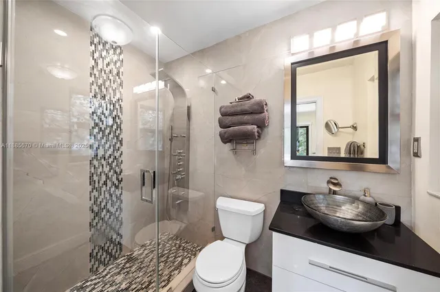 a bathroom with a sink toilet and shower