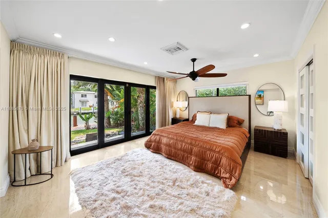 a bedroom with a large bed and a large window