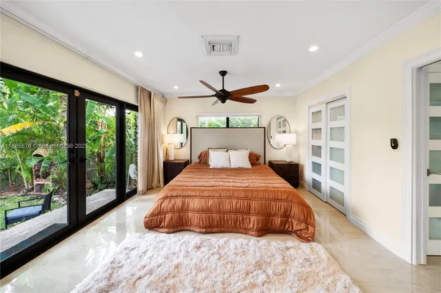 a bedroom with a large bed and a large window