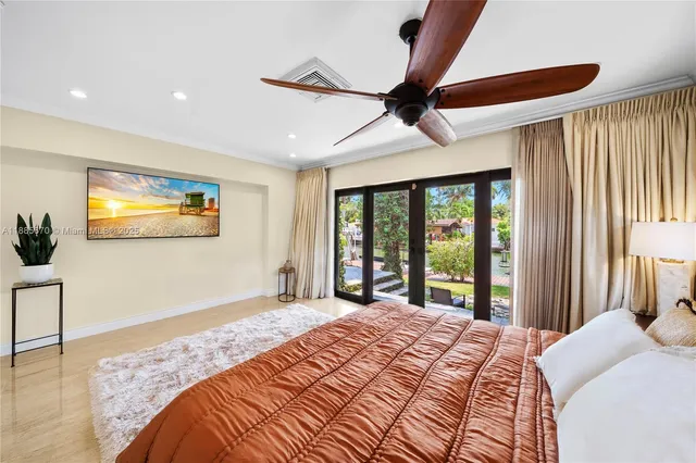 a bedroom with a large bed and a large window