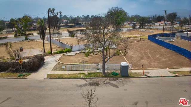 a white house with a yard and ocean view